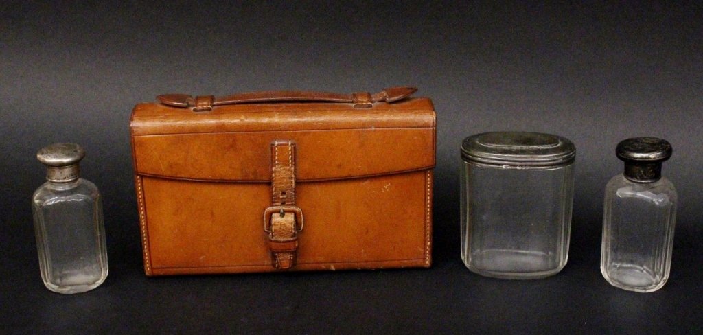 Sterling Lidded Gentleman's Set & 3 Add. Bottles: British, first quarter of 20th century. Percy Horace Arthur Whitehouse brown leather cased set of four gentleman's bottles, each with monogrammed "G" on rounded sterling silver lid, marked with maker'