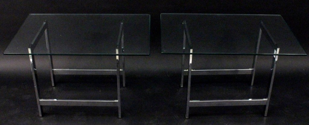 Pair of Modern Chrome & Glass Side Tables: American, 20th century. Matching pair of modern chrome metal and glass rectangular side or occasional tables in the style of Milo Baughman. Each with thick glass rectangular top resting on tubular min