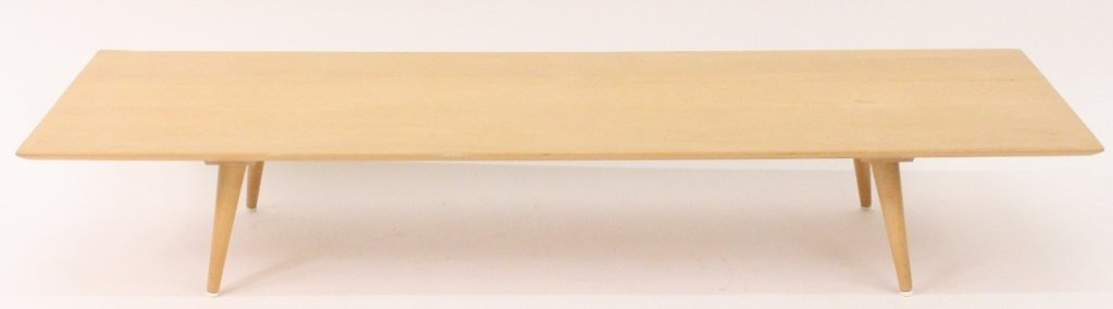 Paul McCobb Low Coffee or Cocktail Table: American, 20th century. Mid century modern Paul McCobb Planner Group maple wood low coffee or cocktail table with long rectangular top raised on four canted and tapered cylindrical legs. Unmarked. Hei