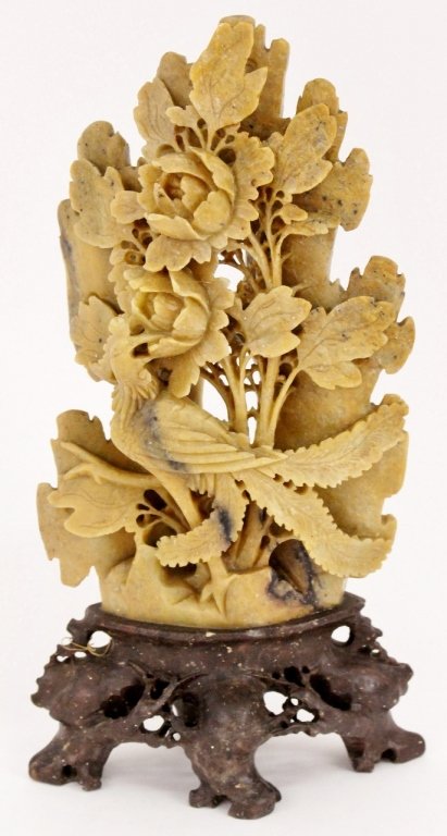 Chinese Soapstone Carving of Bird w/Peonies: Chinese, 20th century, possibly earlier. Light brown or tan soapstone hand carved with phoenix bird beside large peony flowers. Carving raised on a dark brown carved stone base. Unmarked. Overall heig