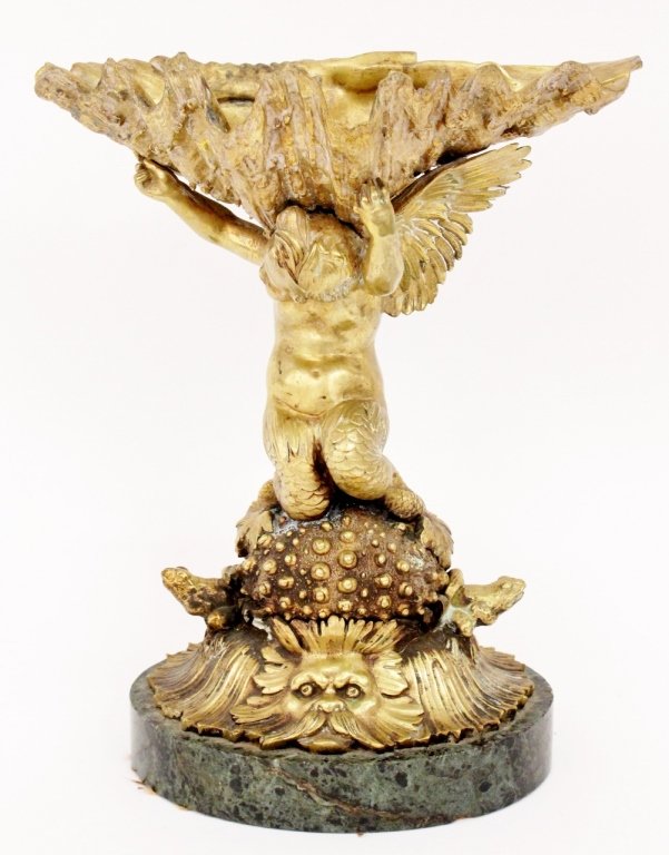 Continental Gilt Bronze Figural Comport Stand: Continental 20th century gilt bronze figural comport stand centerpiece tazza modeled as a oyster shell, held aloft by a winged cherub with mermaid legs kneeling on a sea urchin flanked to each side wi