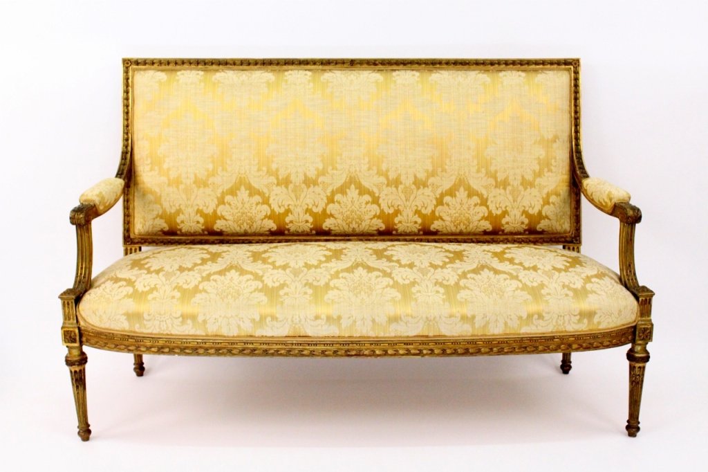 Louis XVI Style Gilt Wood and Upholstered Settee: French. 19th century. Louis XVI style giltwood carved and upholstered settee or bench. Settee with top rail and seat rail carved with bead and reed molding over patera. Rectangular padded back issuing