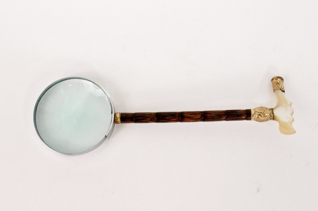 Bamboo & Abalone Handled Magnifying Glass: Magnifying glass with thin bamboo shaft joining circular lens to abalone handle with rolled gold banding at connection decorated with scrolled foliates, end of handle with diamond motif. Magnifying gl
