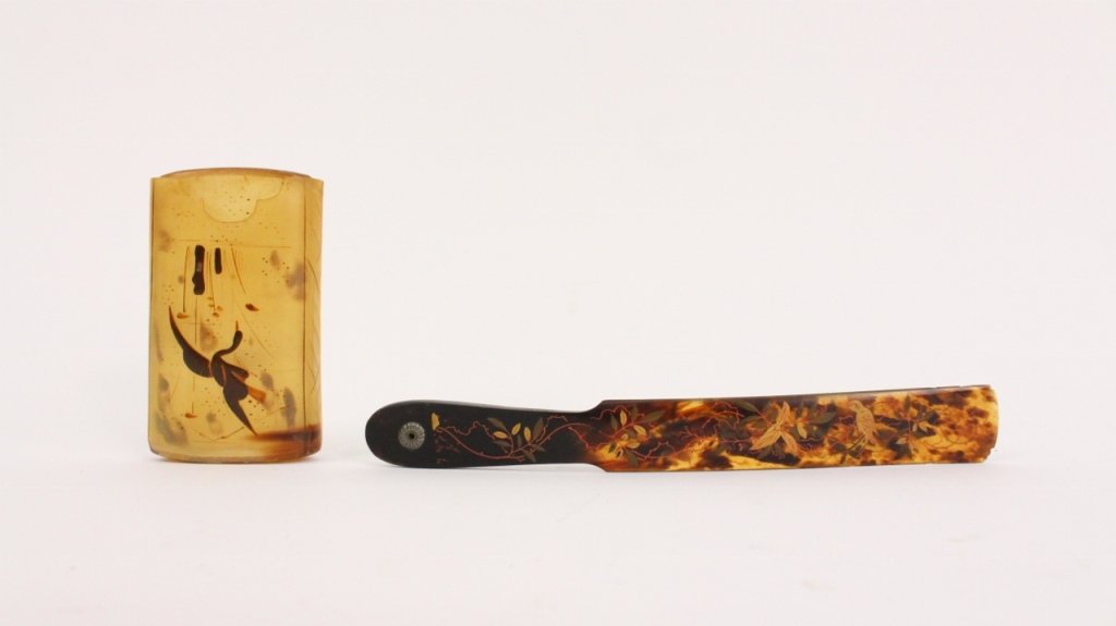 Group of 2 Asian Tortoiseshell Items: Group of two Oriental tortoise shell items comprising of a paper knife decorated with hand painted flowering vines and perched birds (approximately 9" long); and a lidded oblong box with rounded ends