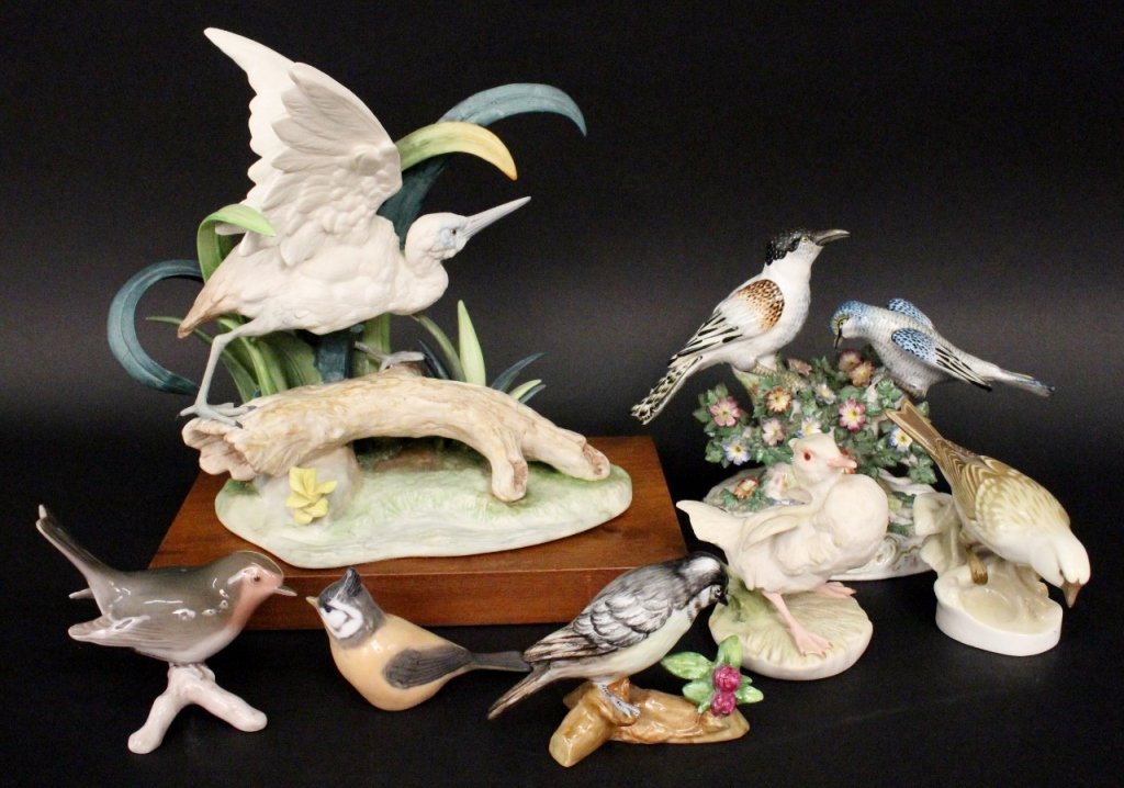 Group of 7 Bird Figurines, Some Cybis: 20th century. Group of seven collectible porcelain bird figurines comprising of a Cybis figure of a white winged little blue heron on a log in wetlands; a Cybis white baby brother white duckling; a br
