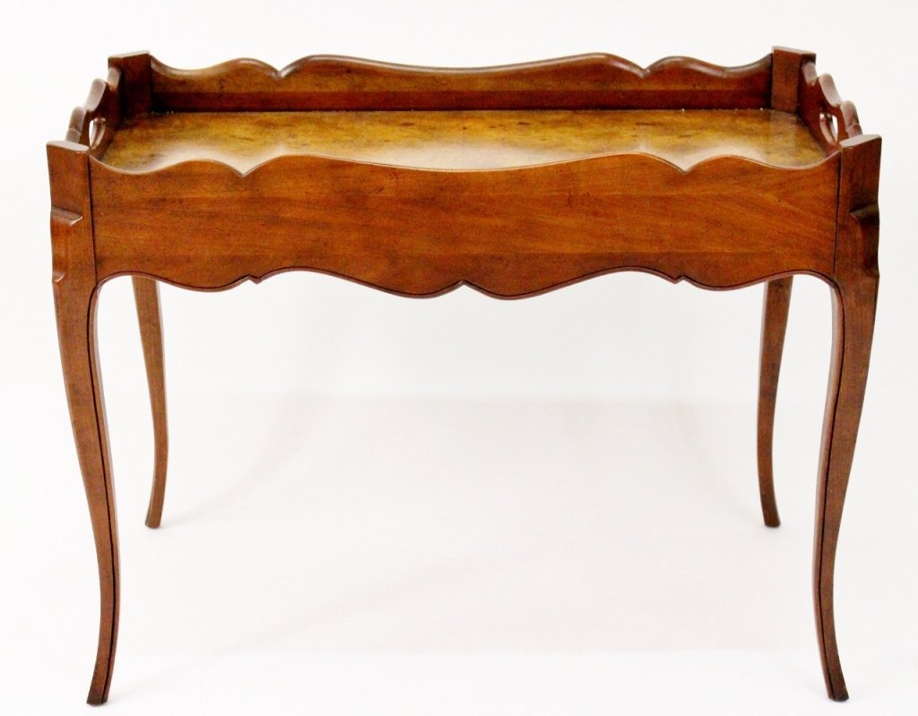Baker Circassion Walnut Occasional Table: Baker Furniture, 20th century. French-style occasional or accent table composed of walnut and circassion walnut wood. Table with rectangular tray style top with shaped gallery, pierced handles and cha