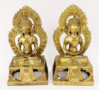 Pair of Gilt Bronze Oriental Guanyin Sculptures: Pair of two matching gilt bronze Asian Guanyin Buddhist deity sculptures or bookends. Each with bodhisattva seated in lotus position and holding water jar in palms. Crowned Goddess of Mercy with flame