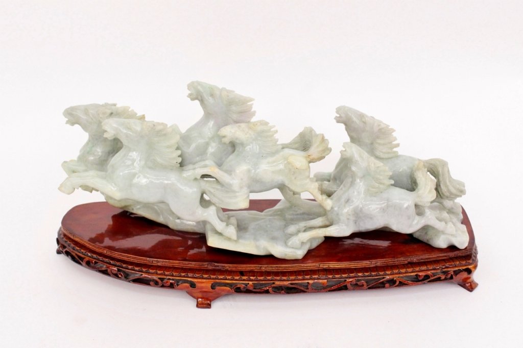 Chinese Carved Celadon Green Soapstone Horses: Chinese, 20th century. Carved figural sculpture depicting a group of six galloping and leaping horses with mouths open and teeth exposed with long mane and raised tails. Animals carved out of light ce