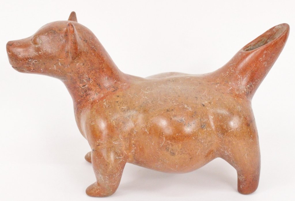Pre Columbian Colima Pottery Dog: Pre Columbian redware burnished and slipped pottery dog, Colima, circa 200 BC-200 AD. Dog figure depicting standing on all four legs, head with perked and alert ears, almost almond shaped eyes, and cl