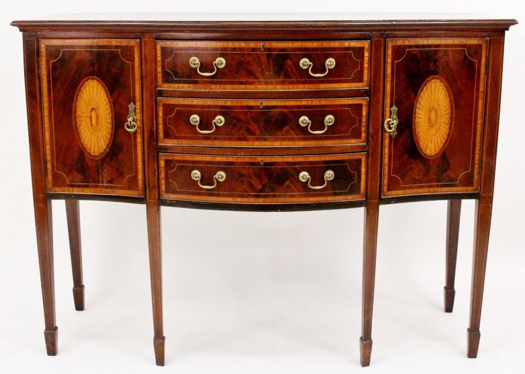 Hepplewhite Mahogany & Satinwood Inlaid Sideboard: 19th Century. English Hepplewhite mahogany and satinwood inlaid sideboard with serpentine banded top above three cockbeaded curved pull out drawers on front with banded and string inlay decoration and