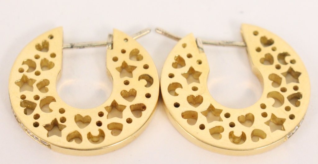 18K Yellow Gold Hoop Earrings: 18k yellow gold hoop earrings with a design of open hearts, moons and stars on the sides and bead set line of round diamonds weighing approximately 0.36 carats. 2mm wide by 7/8" long. 13.7 grams.
