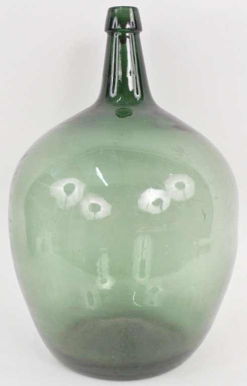 Large French Green Glass Wine Bottle: French, Late 19th/Early 20th century. Large hand blown green colored glass wine bottle or cask with tapered neck above bulbous body. Exposed pontil on bottom. Unmarked. Height 21.2".