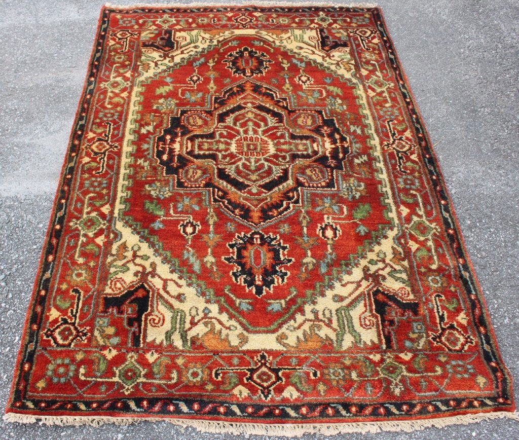 Hand Woven Serapi Area Rug: all wool pile. floral on rust field with cream center. blue, green and gold accent colors. measures approximately 4.1 x 6