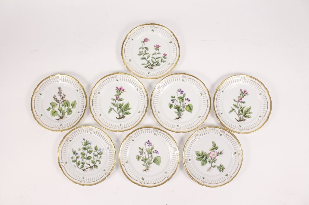 8 Danish Flora Danica Style Porcelain Plates: Danish, 20th Century. Group of eight Flora Danica style porcelain plates,each with reticulated and gilded border, hand painted polychrome enameled centers with different botanical or floral design on