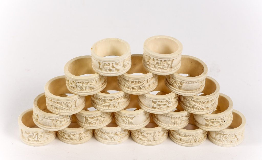 Group of 20 Carved Ivory Napkin Rings: 19th century. Group of 20 carved ivory cylindrical napkin rings comprising of two patterns (12 with carved band with dragon motif, 8 with carved floral motif). Some with monogramming. Dragon motif rin