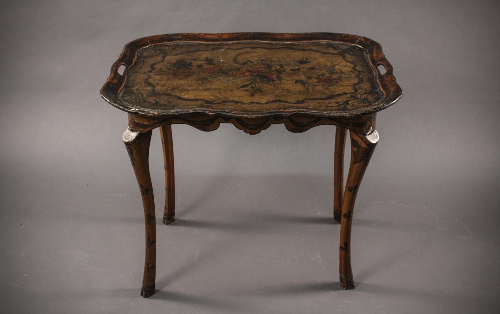 Continental Paint Decorated Butler's Tray Table: Continental. 19th Century. Paint decorated Butler's tray table with serpentine shaped top and pierced handles to each side, the top centered with painted bird perched amidst flowering foliage over a u
