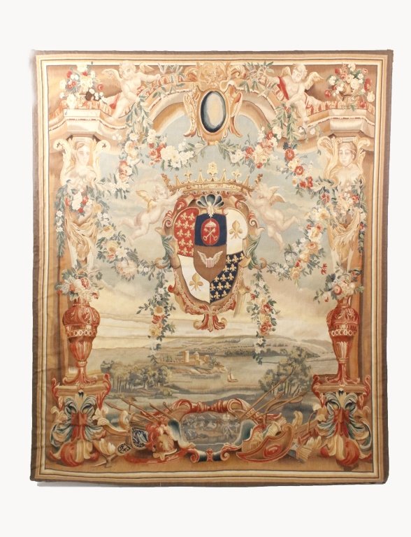 Aubusson Style Wall Tapestry w/Landscape & Crest: Continental School, 20th century. Aubusson style figural tapestry with large heraldic coat of arms crest at center flanked by winted cupids ornamented with floral garland swags hanging above a rolling