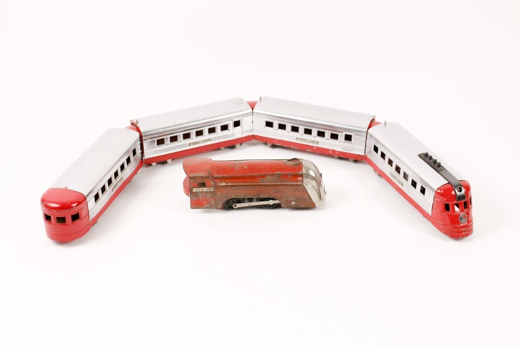 Red Lionel Jr. Train & New York Central Engine: Lionel Lines red and chrome train with engine, two cars and tender; and a red New York Central Lines red "Mercury" engine. Provenance: From the Private Collection of Walter and Alice Glenn, Alpharetta