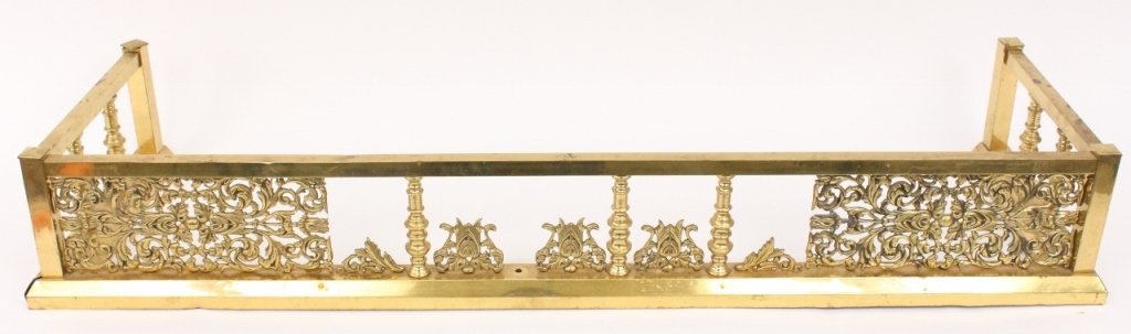 Brass Fire Fender with Pierced Metal Work: Cast brass metal fire fender of standard rectangular form with spool form supports and ornate pierced scrolled foliate and arabesque panels and ornament throughout. Unmarked. Height 7.25", width 48.5"