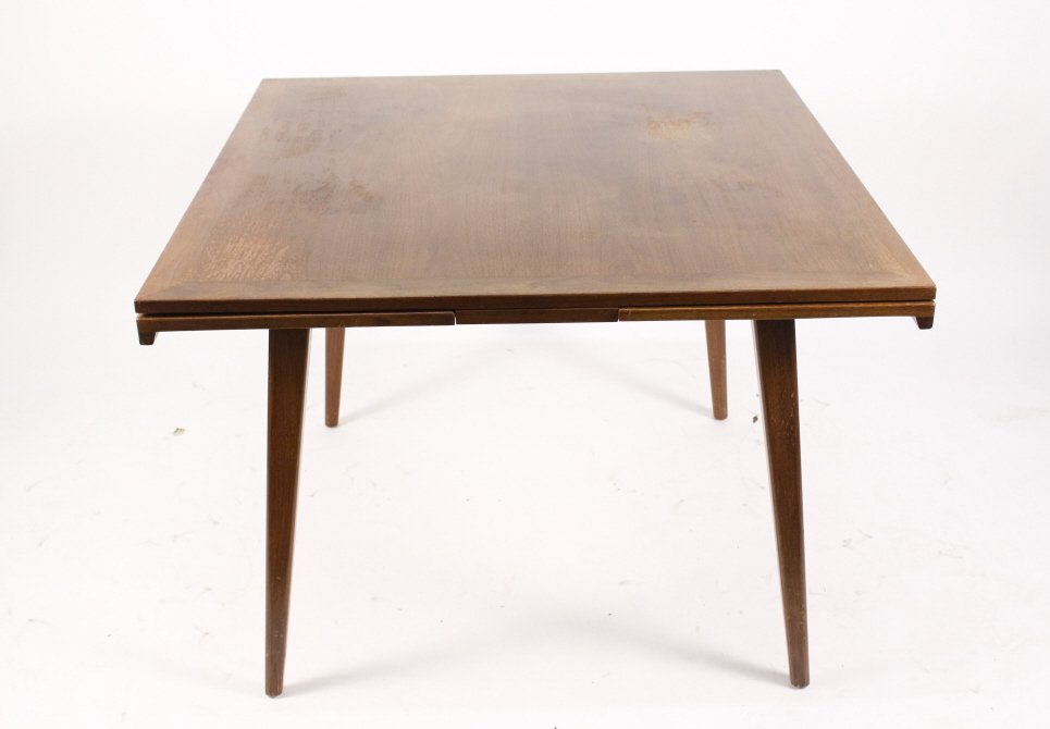 Jens Risom Expandable Dining Table: Jens Risom (Danish/American, b. 1916-), mid century modern refractory dining table composed of walnut wood with tapered lets and streamlined form. Apparently unmarked. Table closed approximate height