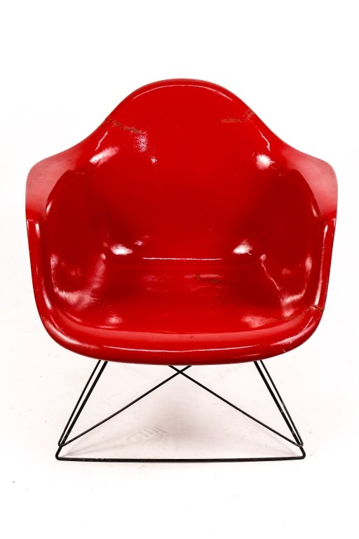 Eames for Herman Miller Fiberglass LAR Chair: Mid-century modern Charles (American, 1907-1978) and Ray Eames (American, 1912â€“1988) for Herman Miller red molded plastic reinforced fiberglass chair (LAR) on tubular black metal base. Damaged 