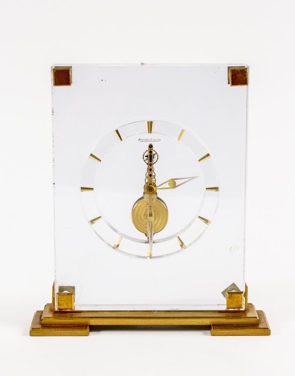 Jaeger LeCoultre Lucite Clock: Jaeger LeCoultre lucite desk or mantel clock composed of vertical rectangular lucite body or case with brass accented corners with circular minimal and modern clock face with tapered hour dashes with 