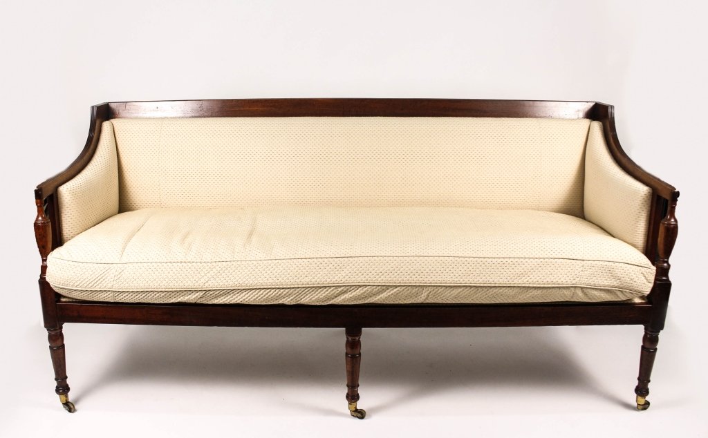 George III Mahogany Upholstered Canape Sofa: English, Late 18th, circa 1795. English George III mahogany wood framed canape sofa with reeded accents on thin arms above tapered turned urn support above blocks raised on six turned wood legs termin