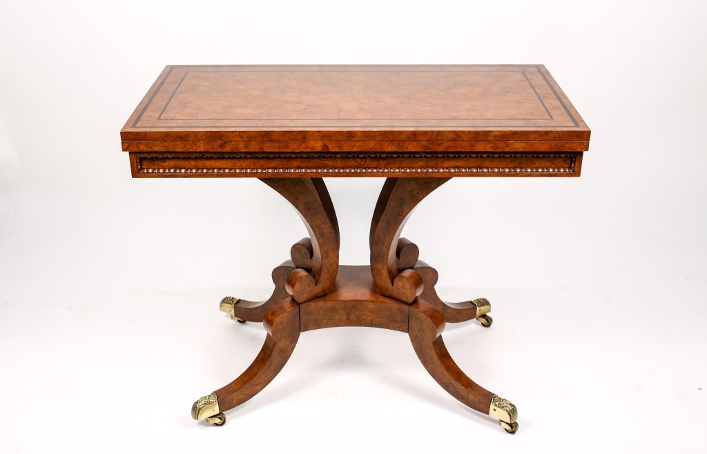 Burl Walnut & Leather Flip Top Card Table by Baker: American, 20th Century. Burl walnut and ebony inlaid flip top, fold over games or card table, with decorative egg and dart moulding, the hinged top opening to reveal a brown leather and gilt tooled in
