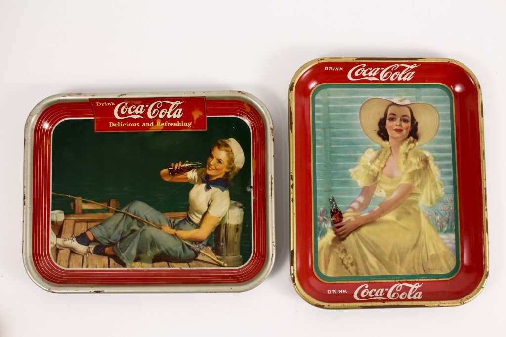 Two Coca Cola Metal Advertising Trays: American, first half of 20th century. Group of two Coca Cola advertising rectangular metal serving trays with raised rims comprising of an American Art Works Inc. (Coshocton, Ohio) for The Coca-Cola C