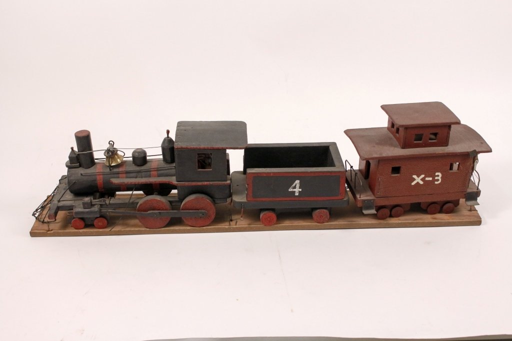Folk Art Carved Three Piece Train Locomotive: American, Late 19th/Early 20th Century. Wooden paint decorated train engine, tender and painted in red and black, with intricate detail, including front lantern, metal fittings, articulated wheels, tr