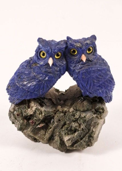 Carved Lapis Lazuli, Tourmaline & Quartz Owls: Harald Schunck (German, 20th century. Finely carved animal figurine of a pair of owls composed of lapis lazuli with pink tourmaline beaks with metal talon feet perched upon a quartz rocky base. Appare