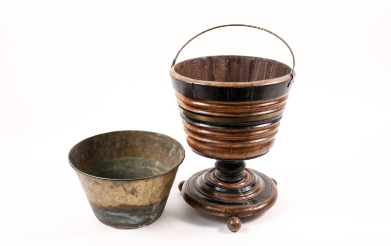 Regency Wood & Metal Peat Bucket: English,18th/19th century. Regency ebonized and walnut wood peat bucket with brass metal strip banding and handle in footed urn form raised on three ball feet. Bucket with removable interior brass met