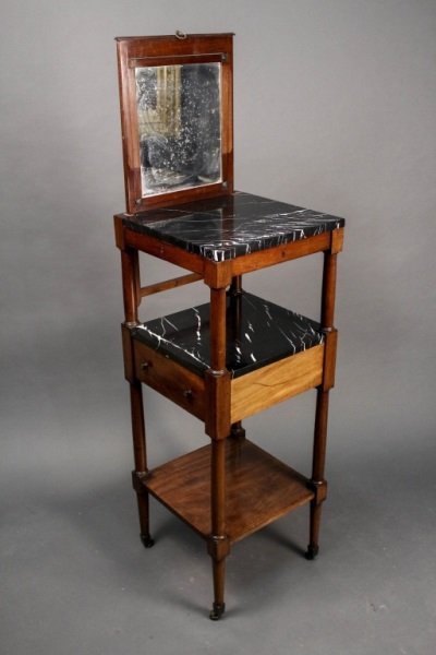 French Empire Shaving Stand w/ Black Marble: French Empire men's shaving stand with black marble top above mahogany wood frame with lift out adjustable rectangular vanity mirror of looking glass. Apron of top tier with small pull out drawer for 