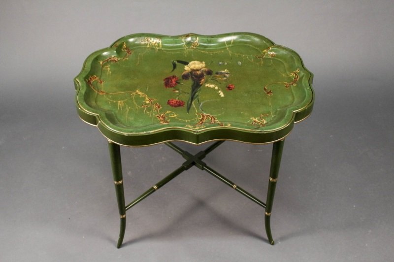 Green Floral Decorated Papier Mache Tray Table: English, 19th century. Green papier mache shaped tray hand painted with iris flanked by red carnations, and other flowers at center surrounded by gilt and black scrolled foliate border supported and r