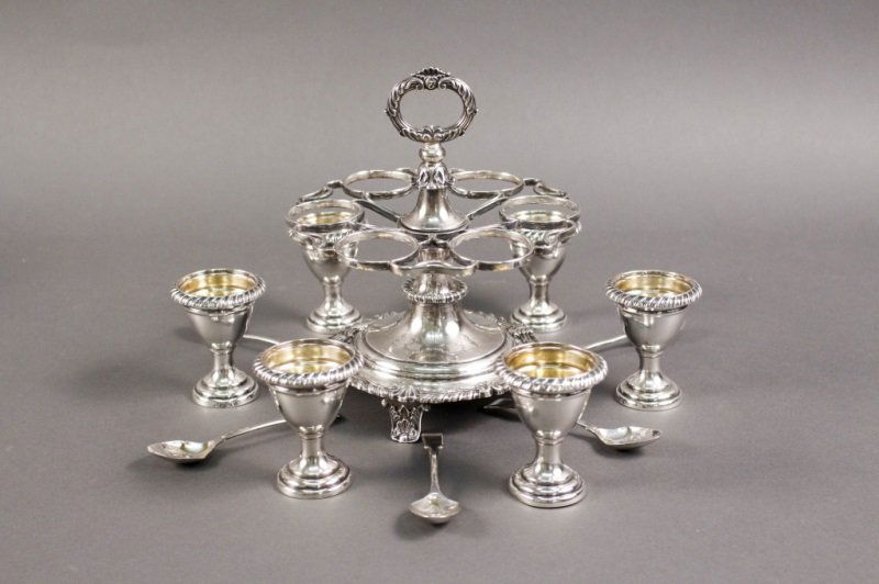 S.C. Younge & Co. Sterling Silver Egg Cruet: S.C. Younge & Co. (English, Sheffield), sterling silver egg cruet with six removable egg holders with twisted gadrooned edge and six coordinating spoons on a stand with foliate and shell motif. Gold w