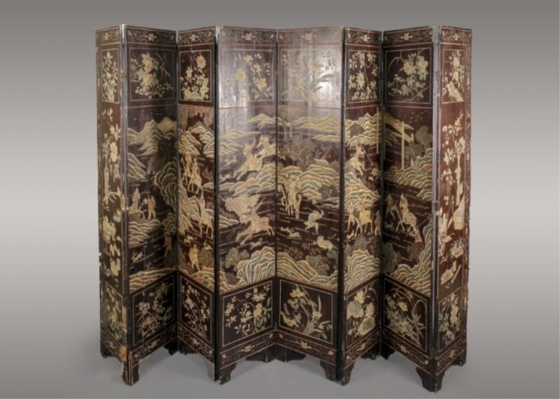 Chinese 8 Panel Coromandel Screen: Chinese, 19th century. Black lacquered eight panel coromandel screen with floral and undulating stem border surrounding central scene of figures on horseback and on foot hunting animals in mountainous
