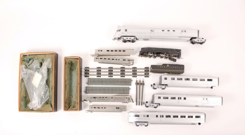 Group of Three Trains, Burlington Zephyr & Others: Collection of three trains and items comprising of a Burlington Zephr engine, two passenger cars and tender; a black and gold Pennsylvania railroad coal car with 940 engine; a Japanese nickel plate tr