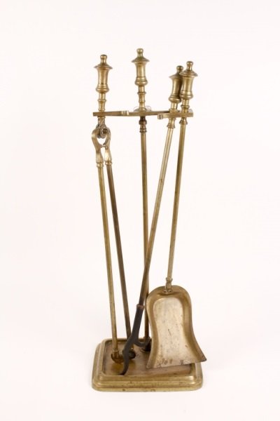 Turn of the Century Continental Brass Fire Tools: Continental, Late 19th/Early 20th century. Set of brass fire tools in stand (circa 1900) comprising of a shovel, poker and tongs. Each with finial form handle. Approximate height 27.5", width 9.5", de