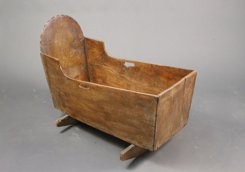 Late 18th/Early 19th C. Carved Oak Cradle: English, Late 18th/Early 19th century. Hand carved oak baby cradle with scalloped edge on arched back, sides with pierced oval handles. Overall with long body raised on two slat rockers. Overall heigh