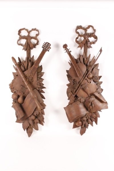 Pair of French Musical Trophy Wall Appliques: Pair of 20th Century French musical trophy wall appliques, composite and molded, both with ribbon tied backplate, one issuing stringed violin with bow, the other with flute and mandolin. amidst foliag