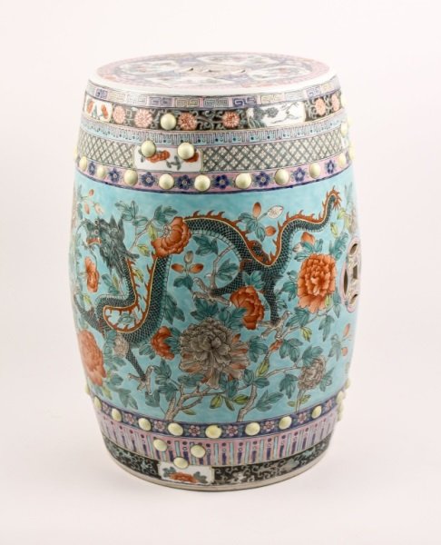 Chinese Famille Rose Porcelain Garden Seat: Chinese, 20th century, possibly earlier. Famille rose decorated porcelain garden seat of typical form with pierced ornament on body and top with opening at bottom. Exterior with diaper patterned, flor