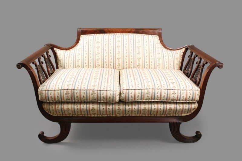 Duncan Phyfe Style American Mahogany Settee: American, 19th Century. Duncan Phyfe style mahogany carved settee with tablet form crest rail and upholstered rectangular back flanked by outscrolled arms and double pierced lyre supports, over a cush