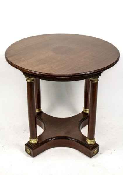 Empire Mahogany & Ormolu Mounted Center Table: French, 19th Century. Empire mahogany & ormolu mounted center table, the circular top overhanging the apron mounted with four ormolu on four column form legs mounted on a concave quadripartite base mo