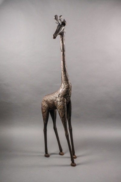 Large Soldered Metal Giraffe Sculpture: 20th Century. Large soldered metal animal floor sculpture of a giraffe with bronze finish and rusted coating on hoofs. Height 64", width 18", depth 8".