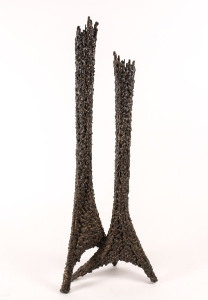 Brutalist Iron Twin-Body Candle Pricket: 20th Century. Brutalist iron twin body candle pricket, stark and vertically angular, the pricket spire mounted to the top of each. The bodies joined together towards the base and resting on four legs.