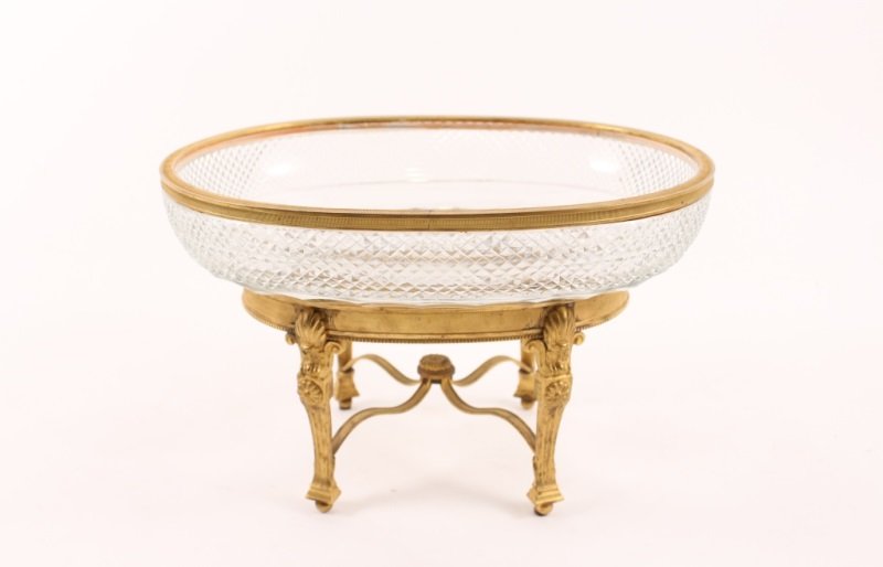 Cut Crystal Centerpiece Bowl on Bronze Base: Cut crystal centerpiece bowl with decoration in the form of diaper patterning and starbursts, on a gilt bronze metal footed base with rosettes and scrolls. 9" x 11" x 8.5".