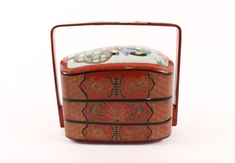 Oriental Lacquered Papier Mache Bento Box: Asian, First half of 20th century. Oriental red lacquered papier mache handled bento box with three rectangular storage compartments. Top with pink peony floral arrangement in vase. Sides of compartme