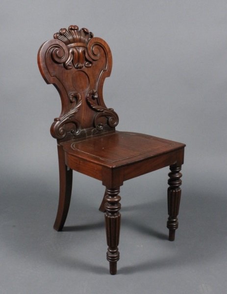 English Mahogany Hall Chair w/ Prince of Wales: English, 19th century. Late Regency period carved mahogany wood hall chair with shaped and carved back with Prince of Wales feathered plume at top with scrolled and recessed panels seat above ring tur