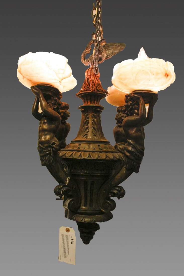 Renaissance Revival Style 4 Light Chandelier: Renaissance Revival style figural chandelier with four electrified lamps supported on holders supported above shirtless men with curled hair and muscular chests with draped fur pelts around waist (men