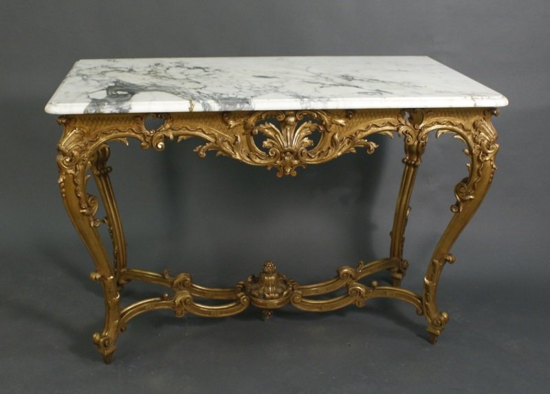 French Louis XV Style Giltwood MT Console Table: French, 20th century. Louis XV style console table with cream and grey rectangular marble top raised on a carved, pierced and giltwood frame with C scrolls, leaved, and diamond diaper patterned frame